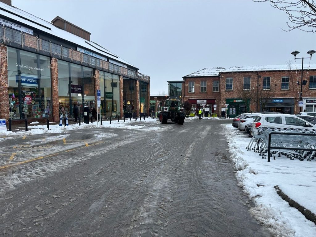 Clearing Car Park Of Snow
